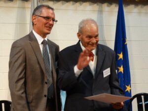 Consul General Mr Victor Grech (left) presents the award to Mr Romeo Cini